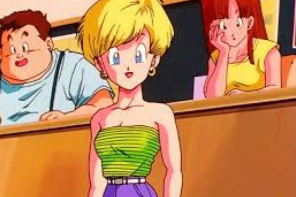 Jeune femme blonde aux cheveux courts, portant un haut vert rayé et une jupe violette, souriante dans une salle de classe ; personnage d’Erasa dans Dragon Ball Z.