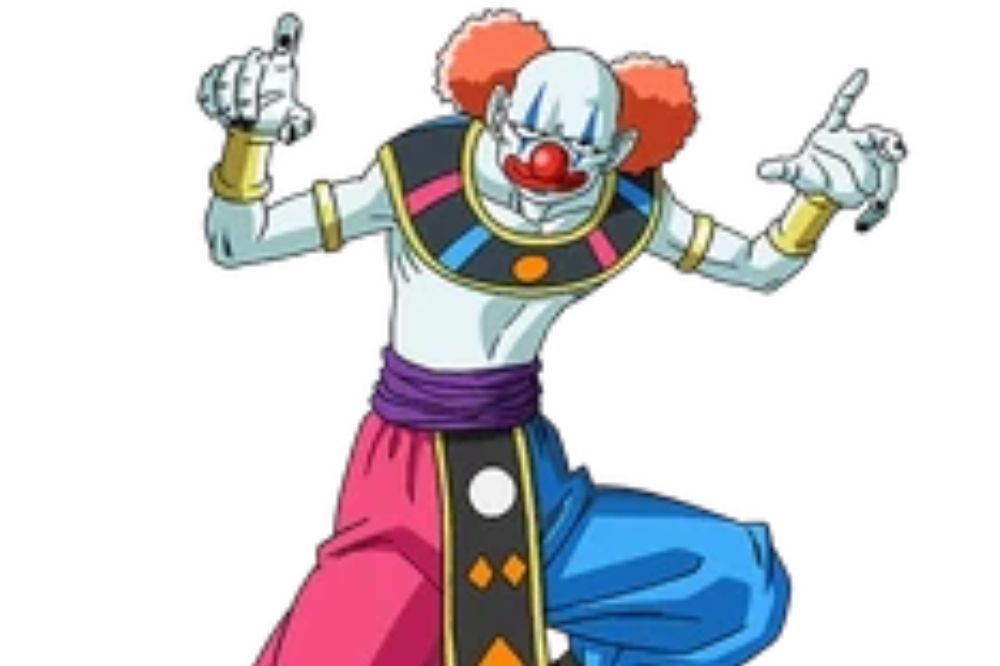 Personnage à l’apparence de clown, au nez rouge, aux cheveux bouffants orange, vêtu d’une tenue divine colorée avec un pantalon bleu et rouge.